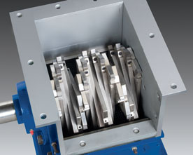 Depending on RPM, cutter tips attached to a helical array of staggered holders continuously shear and/or shatter oversize materials against twin, stationary bed knives with minimal fines or heat generation.